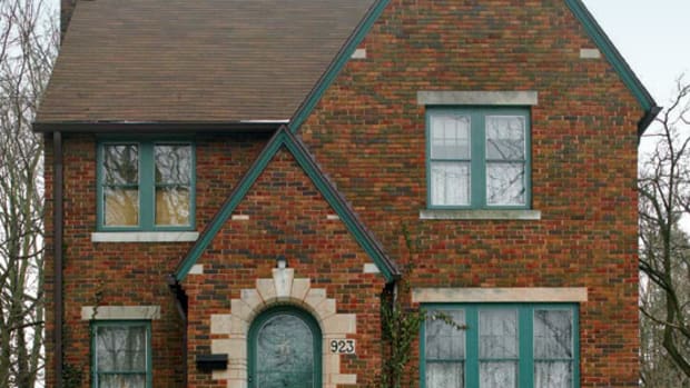 The modest Tudor Revival house, built in 1926, charmed these owners with its brick exterior and arched front entry.