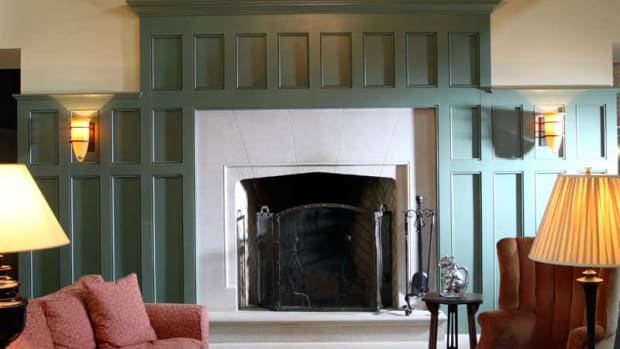 At one end of the beamed great room is a Tudor-style Rumford fireplace with a limestone hearth and surround.