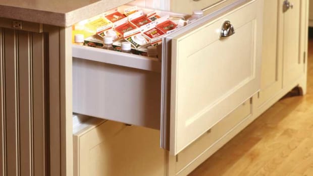 A refrigerator drawer in a kitchen by Crown Point Cabinetry.