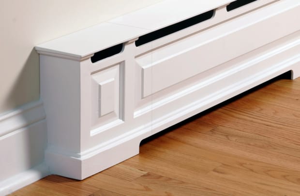A baseboard heater is turned into room trim with a cover by OverBoards.