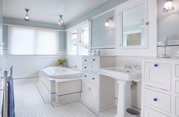 The master bath has plenty of storage in cabinets inspired by 1920s millwork.