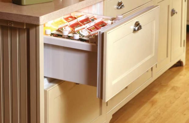 A refrigerator drawer in a kitchen by Crown Point Cabinetry.