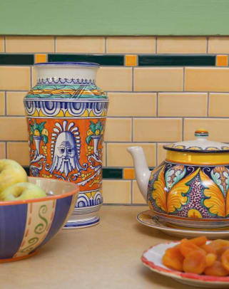 Italian pottery is highlighted against the tile backsplash.