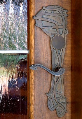 Leaning toward Art Nouveau, an artistic entry doorplate from Heritage Metalworks.