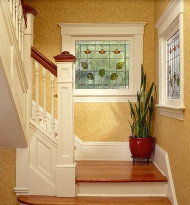 Sanderson's 'Sunflower' paper is illuminated by a stained glass window in the stairwell.