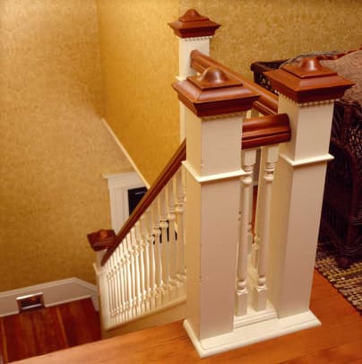 The balustrade at the top of the stairs was re-created when a later bedroom wall was removed. It combines traditional turned balusters with square-stock newel posts.