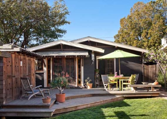 The back deck is bordered on one side by a redwood structure that houses the water heater, washer/dryer, and garden tools. The ventilation cutouts in doors were inspired by California poppies.