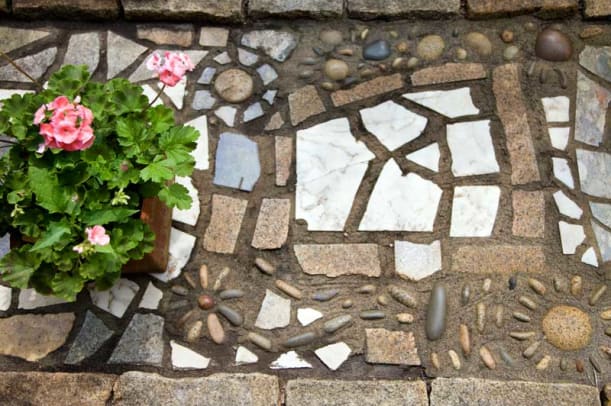 Detail of the mosaic walkway, composed of cut and uncut granite mixed with pieces of discarded marble and granite countertops.