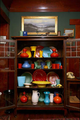 A hutch (maker unknown) displays the best-quality dinnerware in the collection that extends to the kitchen. Contents include Catalina and quite a bit of Bauer.