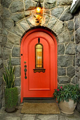 The Mediterranean-style front door is painted in a Southwest red.
