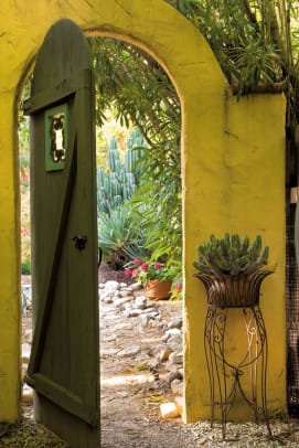 A romantic archway leads from the shady side yard into the front garden.