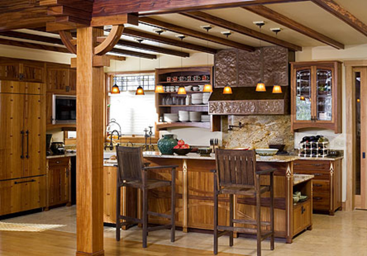 Tucked into a corner, the kitchen is separated from the living room by an embellished pier and the back of the island. The pantry cabinet is off to the right.