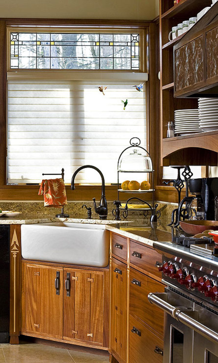 The large, apron-front sink is in the corner beyond the stove. Note the restrained leaded-glass pattern in the Andersen windows.
