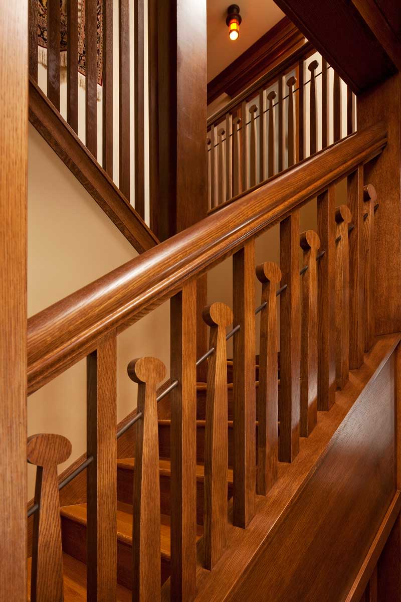 Whimsical balusters repeat a motif common to some Voysey-inspired homes.
