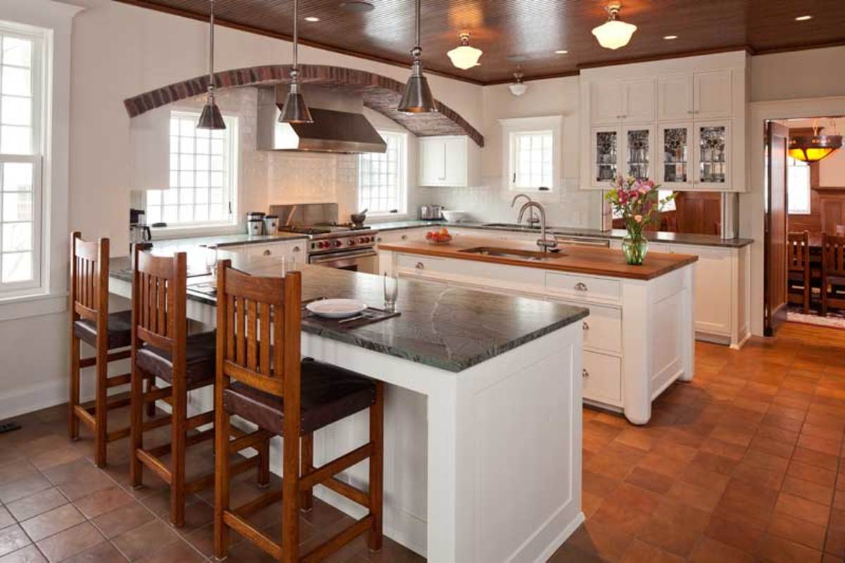 The kitchen has an unusual but practical configuration, offering a room-dividing peninsula, a prep island with a second sink, and a pass-through to the dining room.