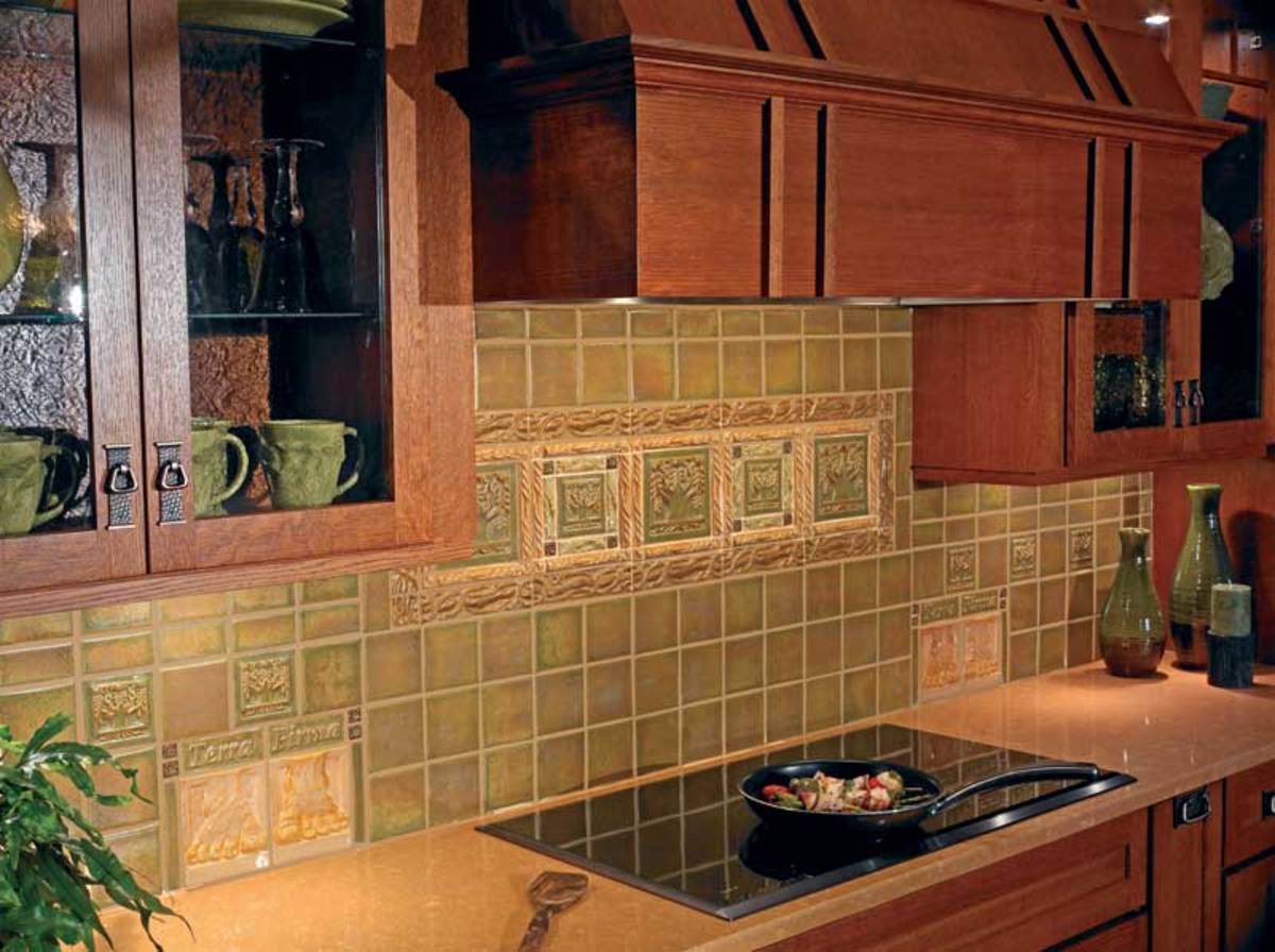 A kitchen backsplash incorporates whimsical pairs of sculpted ‘Foot’ tiles and Terra Firma’s theme tile, ‘Tree of Life’.