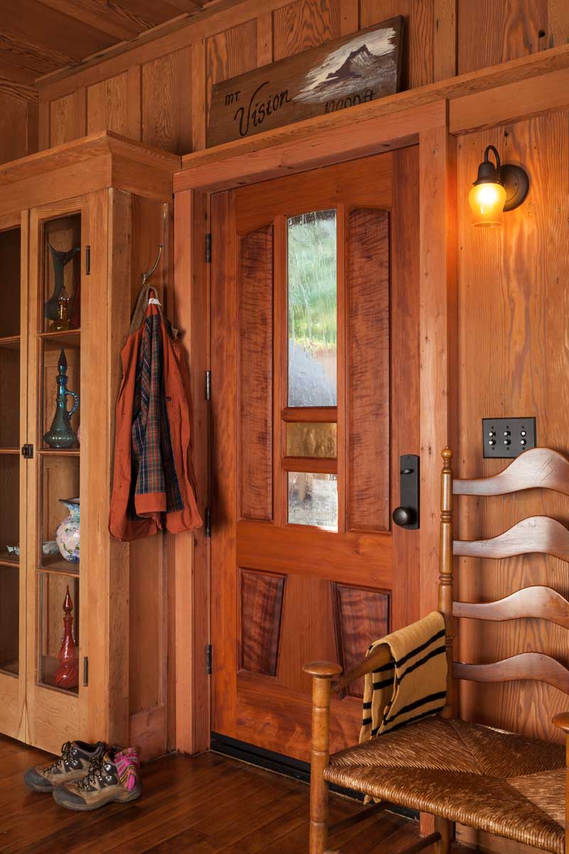 A custom entry by Mendocino Doors was fashioned from scarce, salvaged old-growth redwood.  Photos by William Wright