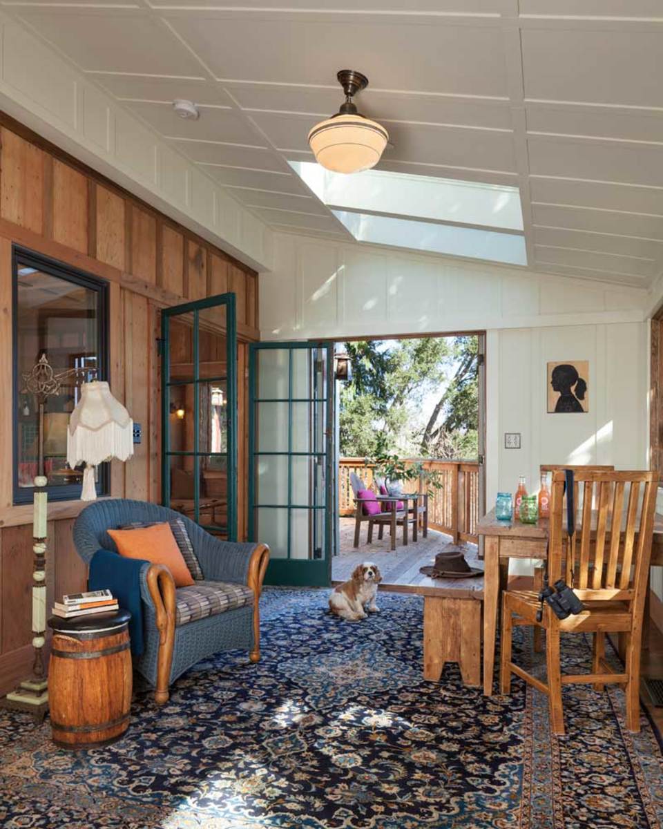 The enclosed sleeping porch that overlooks the water doubles as the dining and family room.