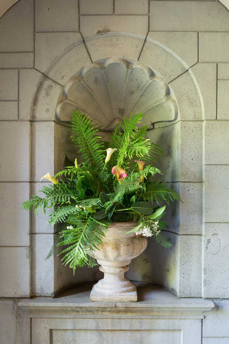 urn with ferns and calla lilies