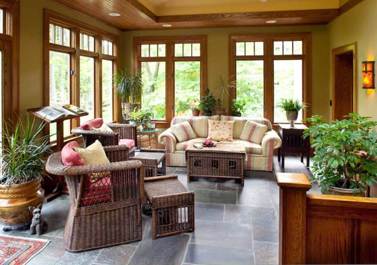 Its bluestone floor keeping the outdoor vibe, the sunroom took the place of a little-used terrace. Salvaged chestnut paneling was used in the half-wall.