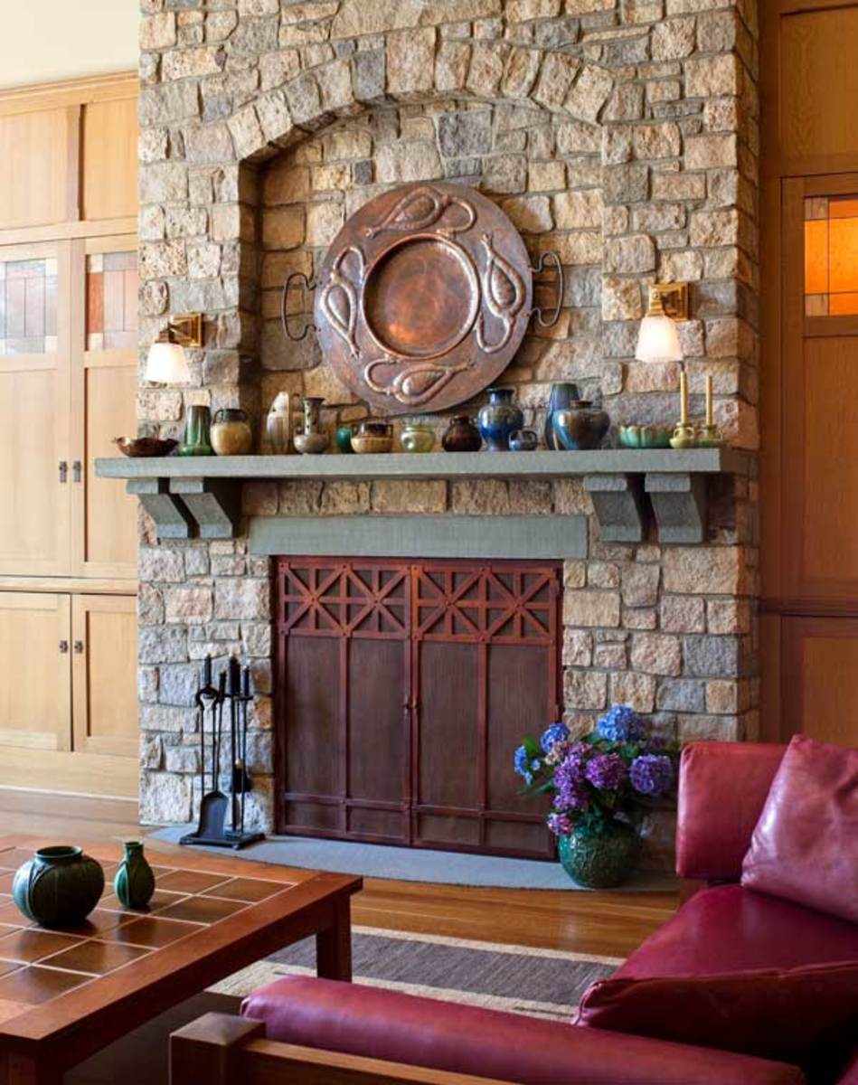 The signature arch is seen again in the stonework of the fireplace. The homeowner collects Fulper and Grueby pottery.