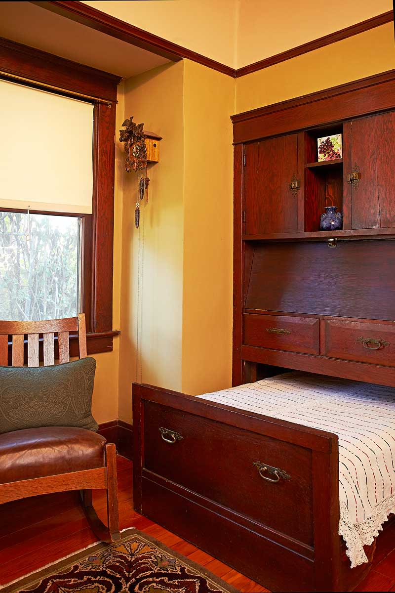 Here’s an original: In what may have been the maid’s room in this 1909 chalet–bungalow, a built-in, drop-front writing desk disguises the twin hideaway bed that rolls out beneath.