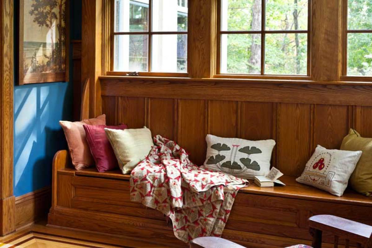 This window seat in an enclosed porch offers extra seating and storage.