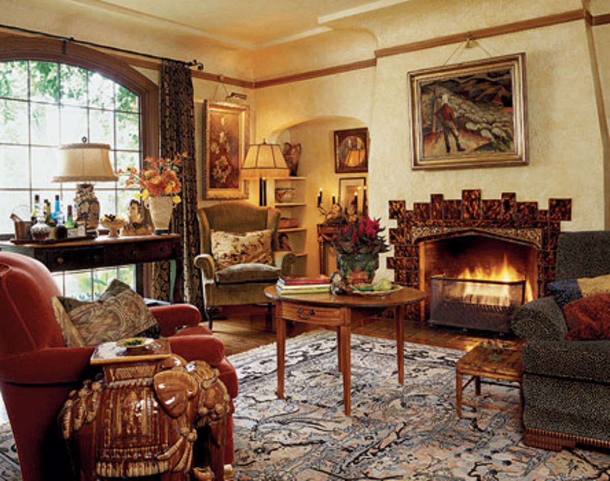 The interior of a 1929 English Tudor cottage has been made lush in the style of 1930s Hollywood: texture abounds in troweled walls, velvet fabrics, and fireplace tiles painted in faux tortoise-shell. Note the coved plaster frieze between walls and ceiling.