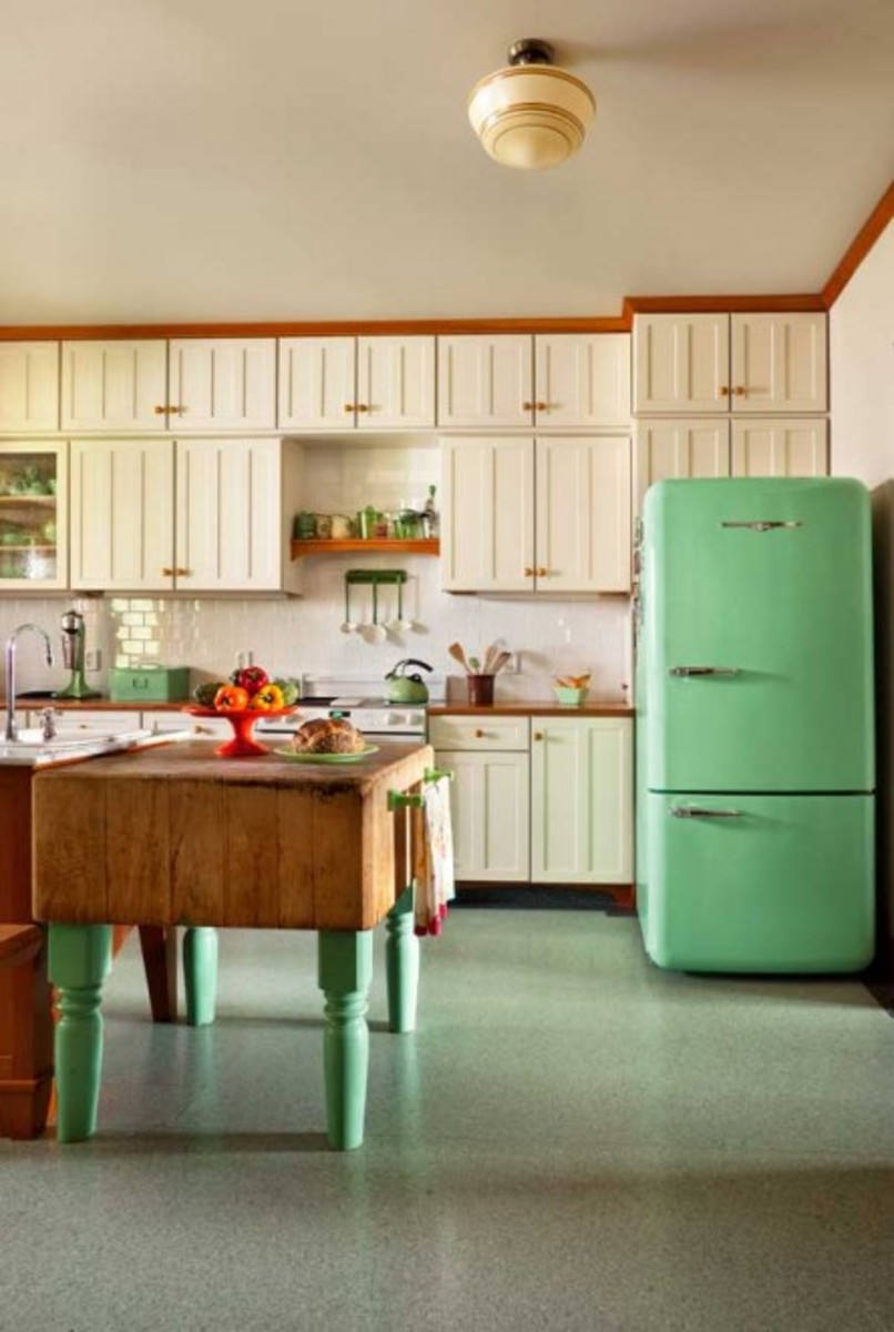The kitchen was built around the butcher-block on legs, an old family piece. The easy-to-clean Marmoleum sheet flooring ties it to the mint-green, 1950s-style Northstar refrigerator by Elmira Stove Works.