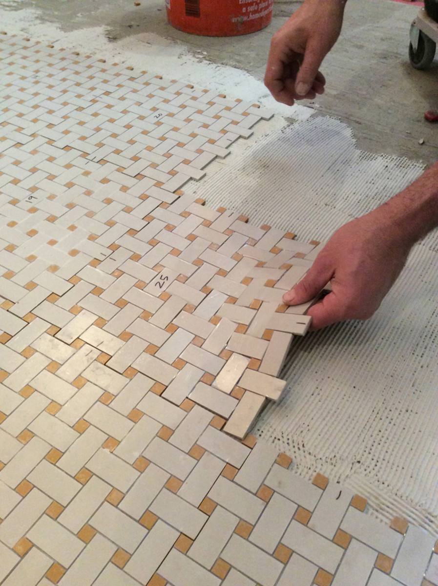 Lay mosaic tile sheets in a row.
