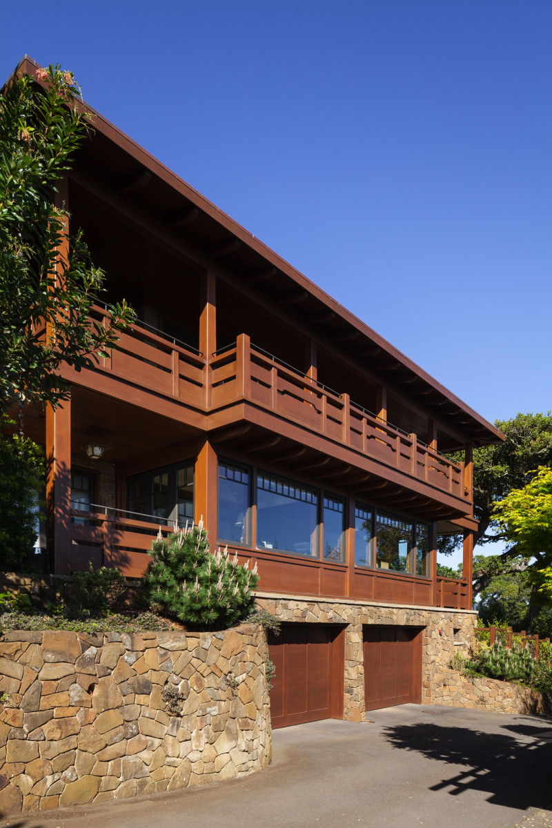 A stone foundation supports two upper levels constructed of Western red cedar.