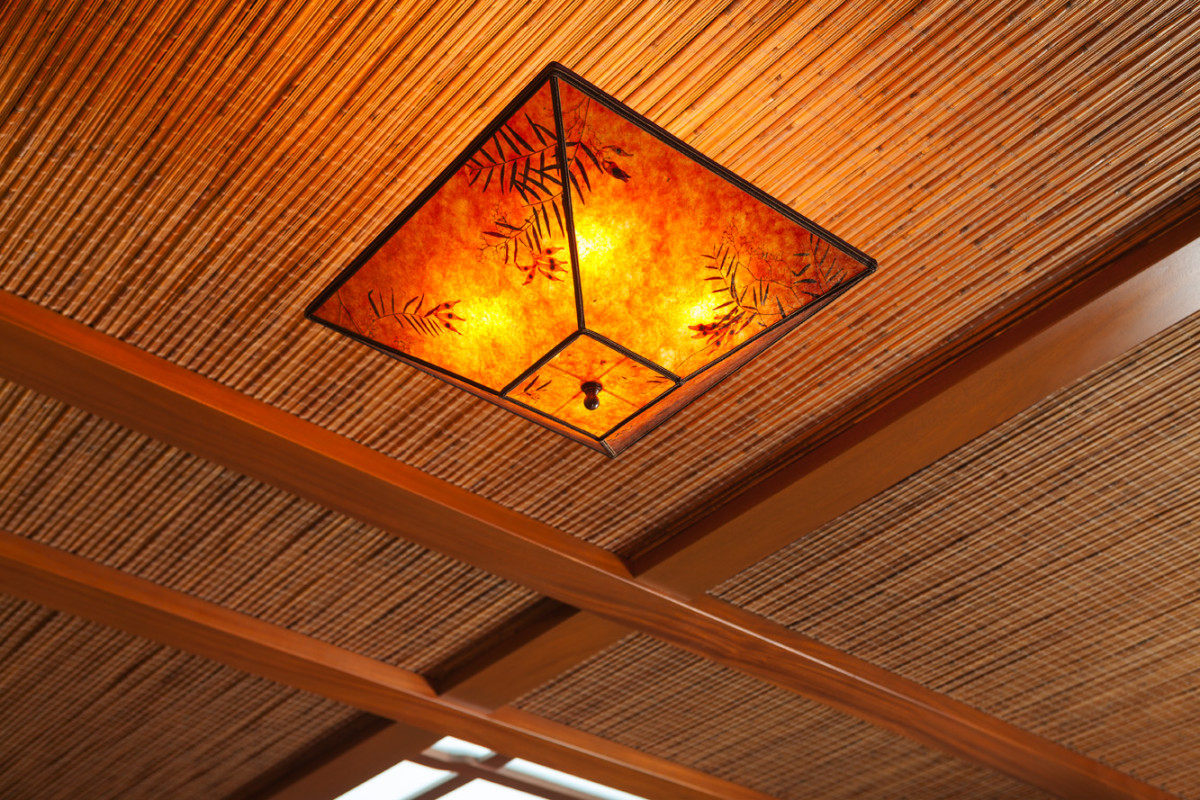 Bamboo reeding between ceiling beams adds warmth.  The ceiling lights have Japanese paper shades by Sue Johnson. 