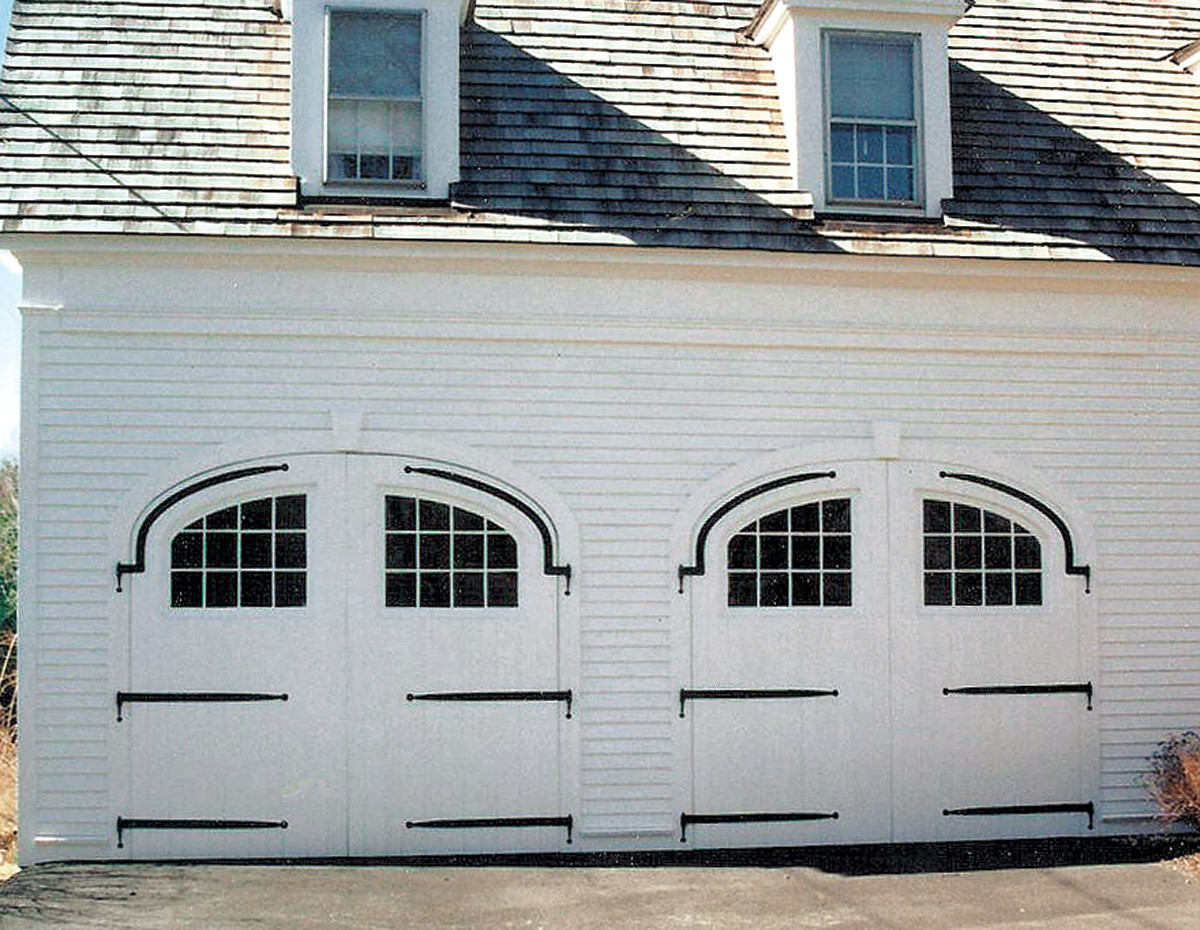 Custom-built arch-top swinging doors by Maurer & Shepherd Joyners have the look of a historic carriage house. 