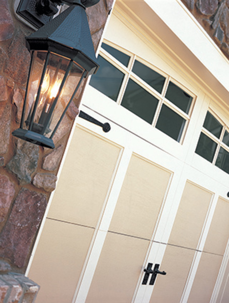 With panels and decorative hardware, an insulated steel carriage house-style door from Clopay resembles a traditional wood door, but requires less upkeep.