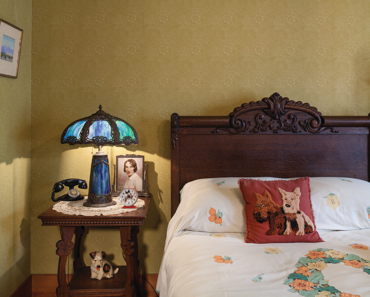 An oak furniture set in the master bedroom came from grandparents. The bed is covered with a ca. 1930 linen bedspread with appliqued and embroidered  nasturtiums.