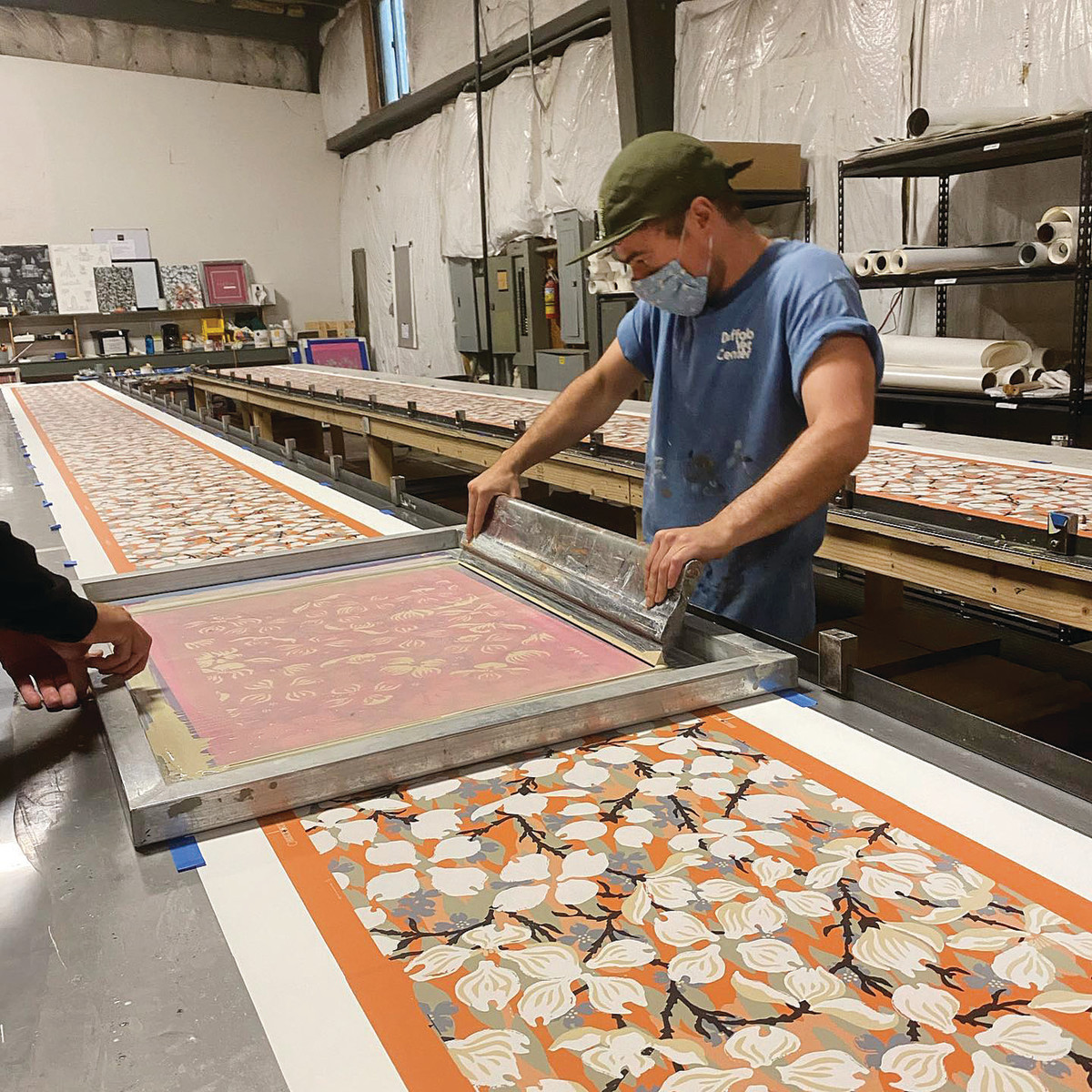 Silk screeners print color layer by layer to produce designs like “Dogwood,” which dates to the early 1920s.