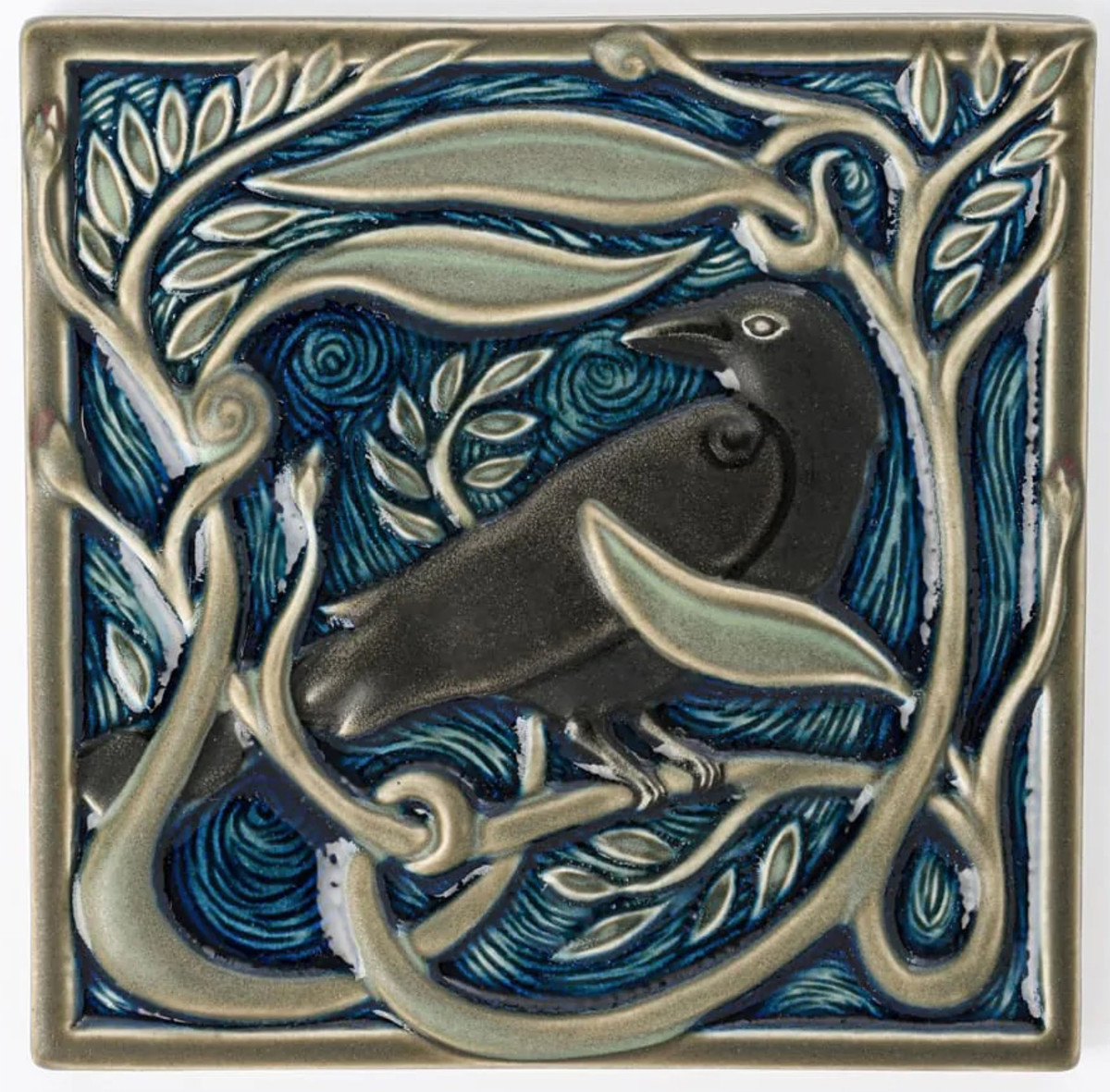 Hand-painted revival-style raven tile by Rookwood Pottery.