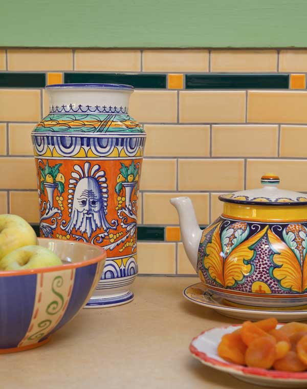 italian-pottery-is-highlighted-against-the-tile-backsplash.jpg
