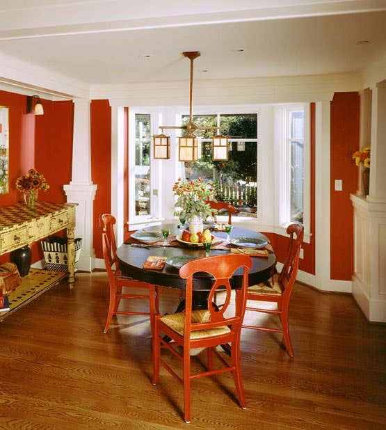 the-dining-room-is-a-highly-colored-complement-to-earthy-rooms-grounded-by-wide-plank-oak-floorboards-with-a-dark-stain.jpg