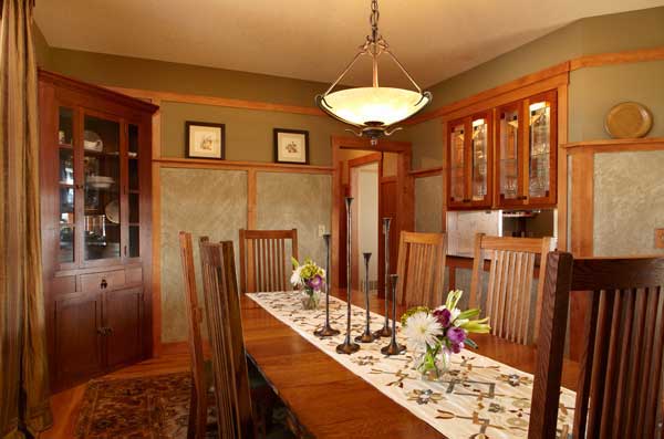 craftsman-influence-is-most-apparent-in-the-cozy-dining-room-where-brown-introduced-silk-drapery-and-a-custom-table-runner-wainscot-panels-are-paint-ragged-with-cheesecloth.jpg
