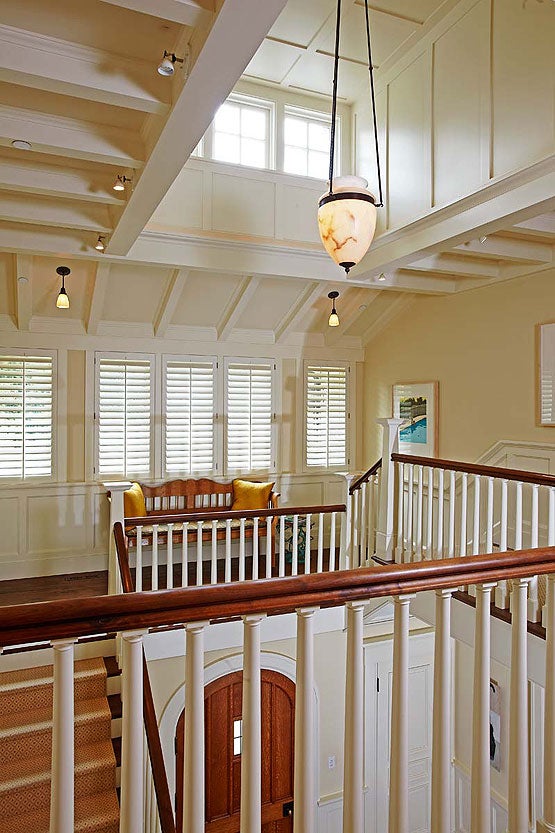 beams-wainscot-and-grouped-windows-lend-scale-to-the-dramatic-entry-hall-rising-three-stories-and-flooded-with-light.jpg