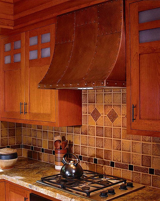 a-modern-cooktop-blends-in-when-accompanied-by-period-cabinets-art-tile-and-a-copper-hood-photo-by-david-duncan-livingston.jpg