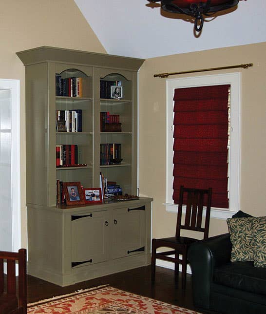 with-a-quiet-coat-of-paint-in-a-period-color-and-reproduction-hardware-the-cabinets-were-made-to-blend-with-the-room.jpg