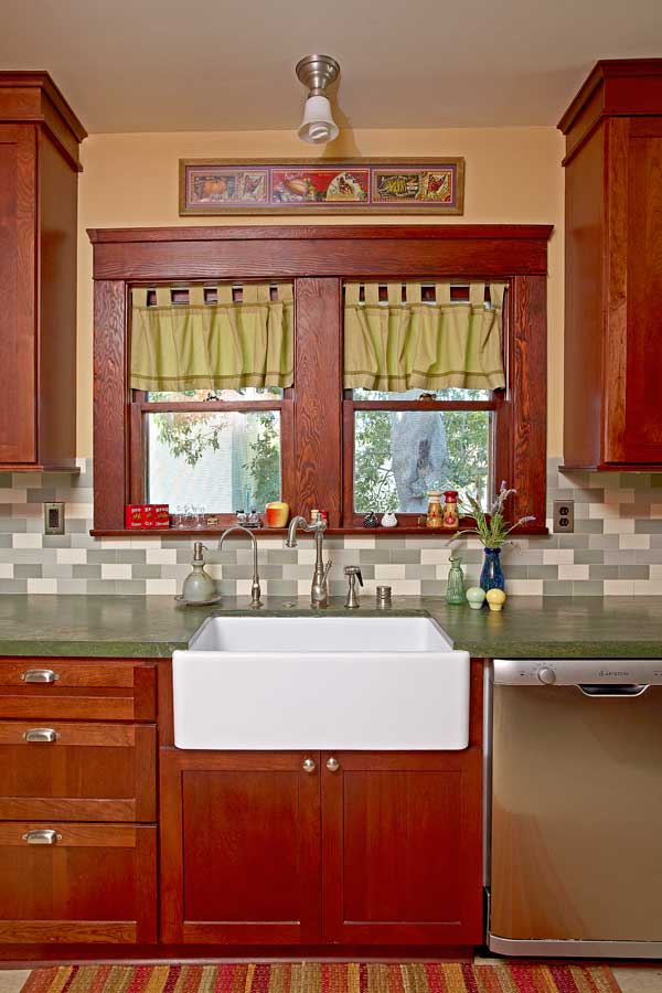 green-tiles-and-granite-complement-red-trim-and-cabinets-in-the-pleasantly-old-fashioned-kitchen.jpg