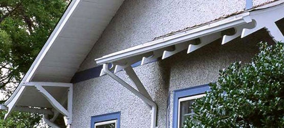 wooden-elements-on-a-stucco-bungalow-include-knee-brackets-and-fancy-cut-rafter-ends-as-well-as-rake-boards-and-under-eave-soffits-photo-national-archives-associates.jpg