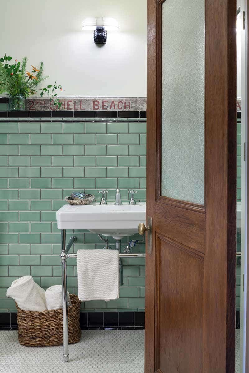in-the-guest-bath-green-3-x-6-subway-tiles-and-a-reproduction-kohler-memoir-pedestal-sink-have-a-vintage-look.jpg
