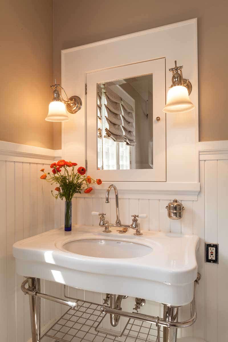 the-first-floor-bathroom-was-returned-to-a-period-look-with-wainscoting-and-woodwork-milled-to-match-that-in-the-rest-of-the-house-and-a-new-built-in-medicine-cabinet.jpg