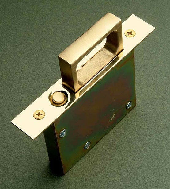3-pocket-door-lockset-mortised-into-the-edge-of-a-pocket-door-this-flush-plate-becomes-a-brass-pull-when-you-push-the-recessed-button-courtesy-crown-city-hardware.jpg